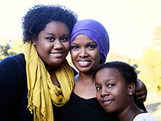 An African American woman and her two daughters.