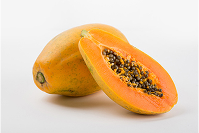 Two papayas with one cut in half