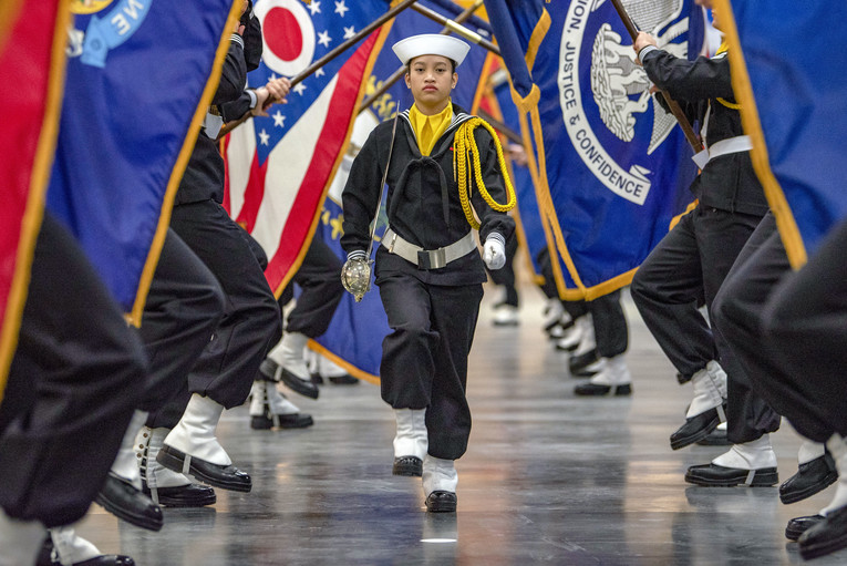 Navy performance division recruits carry state flags.