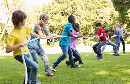 Image of preteen children playing tug-a-war