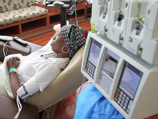 Woman wearing a headscarf getting chemotherapy treatment