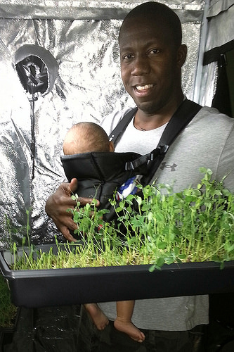Photo of Veteran Farmer holding infant: Permissions USDA photo