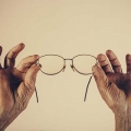 hands holding a pair of glasses