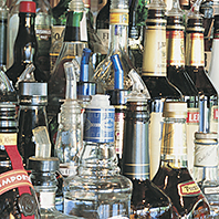 A variety of liquor bottles lined up on a shelf