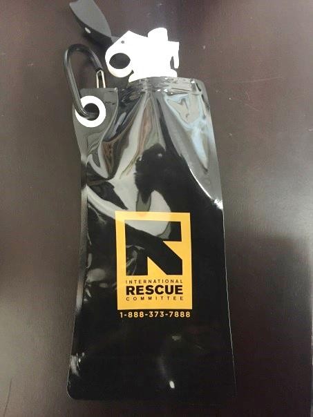 Water bottle with International Rescue Committee logo and National Human Trafficking Hotline: 1-888-373-7888