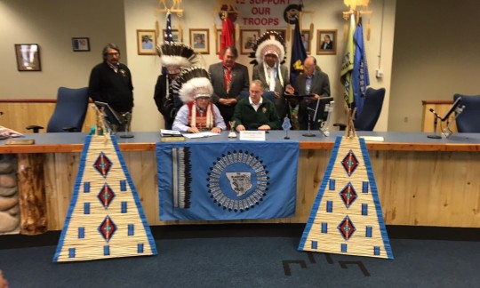 Secretary Zinke sits at a long table in a conference room with members of the Blackfeet Nation.