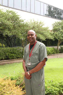 Male hospital worker standing outside building