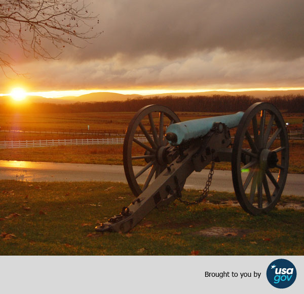 Image of a cannon in battlefield at sunset. Brought to you by USAGov.