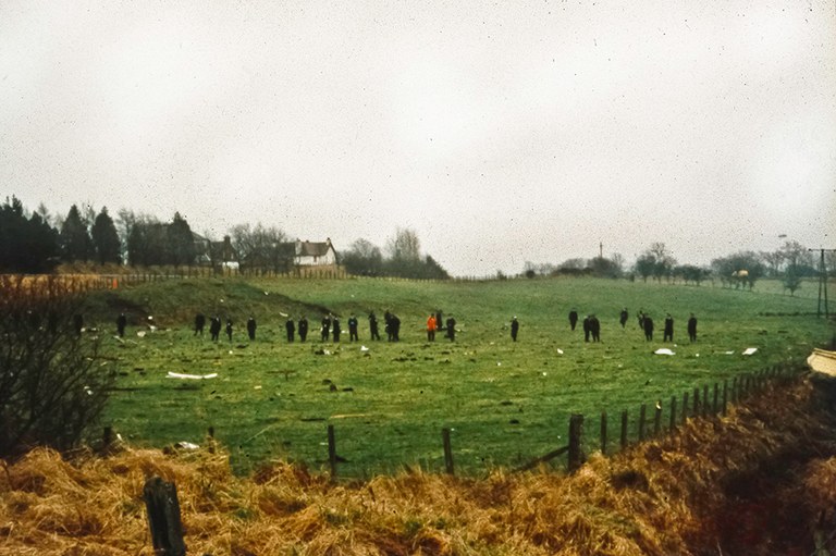 Scottish police officers search for debris and evidence in fields after the December 21, 1988 bombing of Pan Am Flight 103 over Lockerbie, Scotland. (Syracuse University photo)