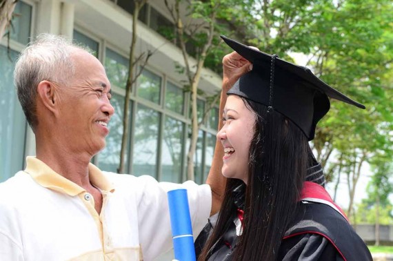 Picture of father congratulating daughter who just graduated from college