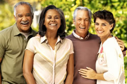 Foto de cuatro personas de mediana edad de diferentes razas.
