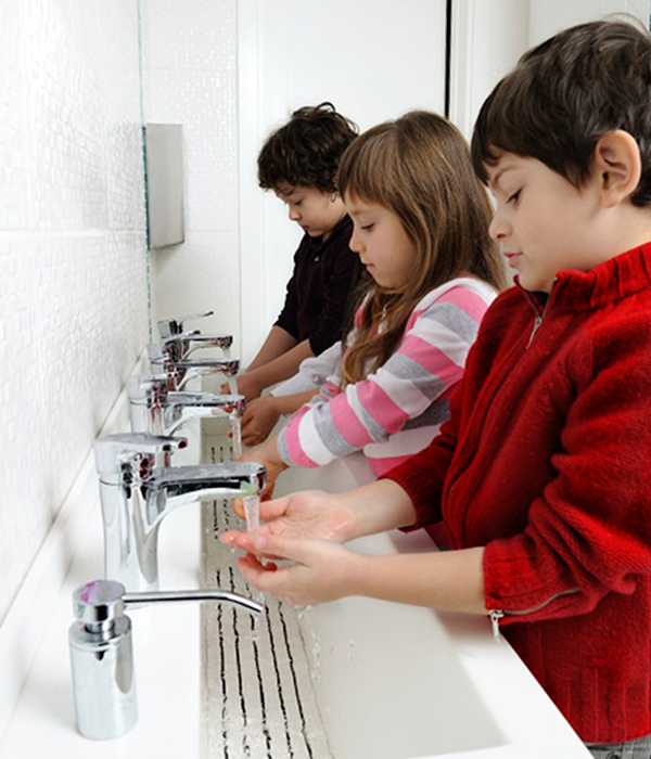 Children washing their hands at school.
