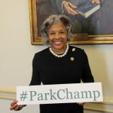 Congresswoman Beatty Stands with "#ParkChamp" Sign.
