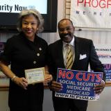Congresswoman Beatty stands with "No Cuts to Social Security Medicare Medicaid" sign.