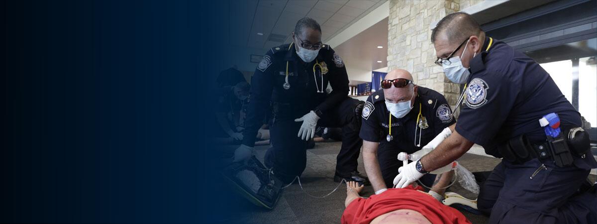CBP emergency medical technician students perform a class exercise using a bag valve mask to resuscitate a simulated patient