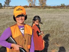 Two girls wear bright vests while learning to hunt on public lands. (Eric Coulter/BLM)