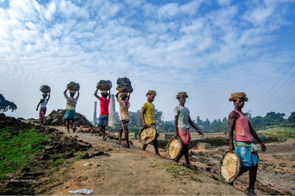 Indian men carry clay and materials to and from a brick kiln. Across India, traffickers force entire families to work to pay off debts, also known as debt bondage. Conditions at brick kilns are extreme; workers often do not have running water and endure excruciating temperatures at sites filled with dust and dangerous chemicals.
