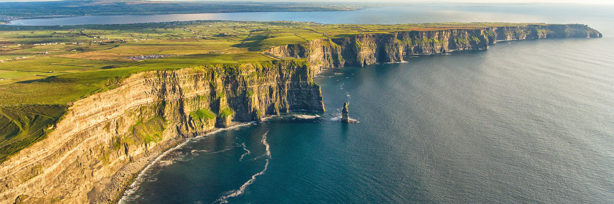 Aerial birds eye drone view from the world famous cliffs of moher in county clare ireland. Scenic Irish rural countryside nature along the wild atlantic way and European Atlantic Geotourism Route - Image [Shutterstock]