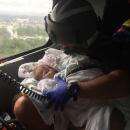 A Coast Guard aircrew assists infant during the aftermath of Hurricane Harvey in the greater Houston Metro Area Aug. 29, 2017. 