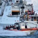 A small boat transfers personnel to the Coast Guard Cutter James, which is serving as a command and control platform in San Juan, Puerto Rico, Sept. 25, 2017. The cutter's crew deployed to aid in response operations and the ship's communications capabilities are being used to help first responders coordinate efforts. Coast Guard photo by Petty Officer 1st Class Patrick Kelley. 