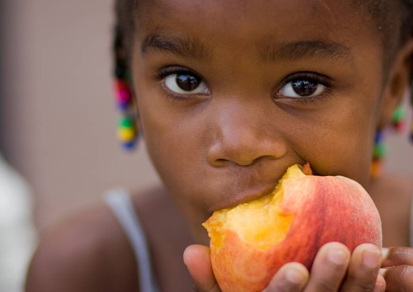 girl eating peach