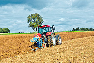 Photo of a tractor in a field of wheat