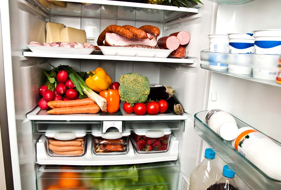 Woman putting food in refrigerator