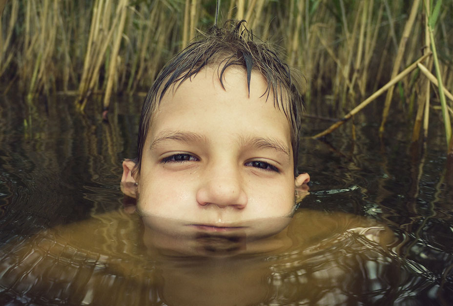 Young boy submerged in water