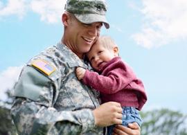 man in uniform holding baby