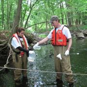 IN-KY scientists collecting water quality samples from a stream