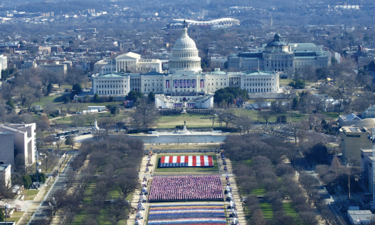 Photo of inauguration with flags and the Capitol