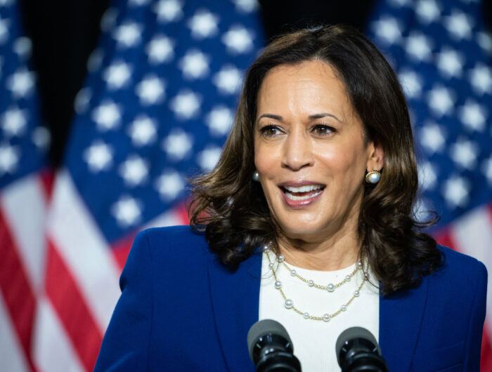 Vice President Harris wears a blue blazer in front of three American flags as she announces her candidacy for Vice President in Wilmington, Delaware