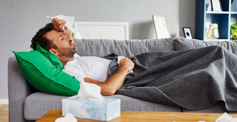 man laying on couch sick
