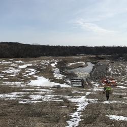 On April 6, USGS hydrographer Spencer Wheeling carries equipment out to measure high water on the Tongue River near Akra, ND. 