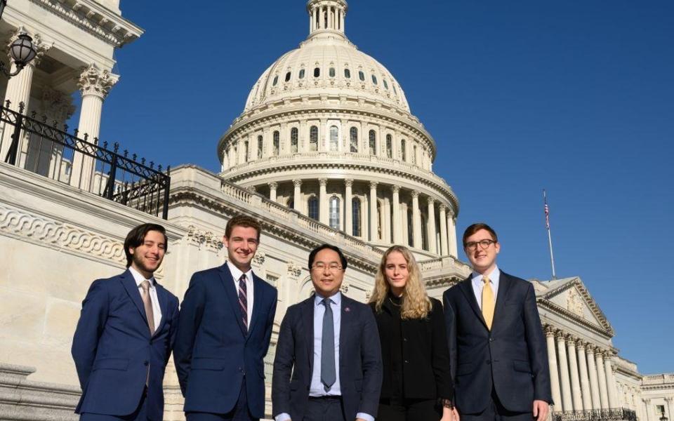 Interns on steps of Capitol with Rep. Kim