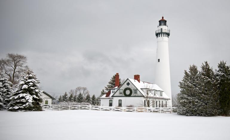 Snow covered scenery of lighthouse and buildings in the winter
