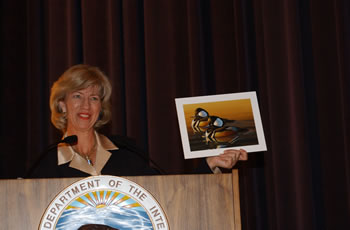 Secretary Norton holding the winning Duck Stamp Contest artwork. 