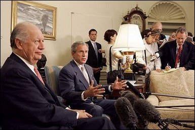 President George W. Bush and President Ricardo Lagos of Chile meet in the Oval Office Monday, July 19, 2004. "One of the things that has worked well is the free trade agreement with Chile, and we talked about that today," said President Bush. White House photo by Paul Morse.