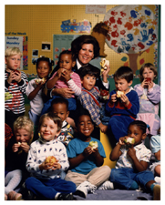 [U.S. Surgeon General Antonia C. Novello in group portrait with children at a daycare center]. [1990?].