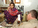 A Special Forces medical sergeant cuts a cast off the arm of a young Afghan girl at a Special Forces medical clinic in the Konar Province.  The girl was treated for her injury at the clinic and was brought in by her father for follow-up care.  This clinic is the only one of its kind for at least 100 miles in every direction and treats more than 100 Afghan patients daily with moderate to severe ailments and injuries.  Ten percent of the clinics patients are Afghan women who previously had no access to heath care.  (Photo by Sgt. Frank Magni, 17th Public Affairs Detachment)