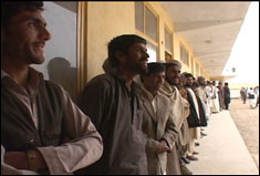 Pfc. Mary Simms, CJTF-76 Public Affairs
(video still)  Afghan men wait patiently in line at the polling center in the village of Raban, north of Bagram Air Field on October 9th during Afghanistan's first democratic presidential elections.
