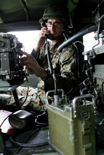 Private First Class Adrian M. Negron, 26th MEU field radio operator, performs a radio check on the single-channel ground and airborne radio system during the Standard Tactical Entry Point Exercise (STEPEX) here Sept. 28. (USMC Photo by Cpl. Eric R. Martin)