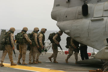 Photo of Marines and Sailots of Charlie Co. BLT 1/3 boarding a CH-46E