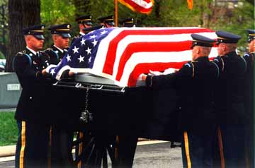 Army casket team place the burial flag over the casket.