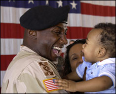 Staff Sgt. James Smith holds his eight-month old son Malik for the first time after returning home to Nevada from a 13-month deployment to Kuwait and Iraq. Smith is assigned to the 257th Transportation Company. This photo appeared on www.army.mil.