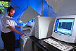  The high-capacity DNA sequencer being loaded by geneticist Curt Van Tassel)