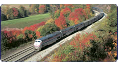 Passenger train traveling through New England, autumn
landscape.