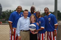 PCPFS Executive Director, Melissa Johnson, and Health and Human Services Secretary Tommy Thompson with the Harlem Globetrotters at the HealthierUS Fitness Festival on the National Mall, June 16, 2004 (Globetrotters from left to right: Bubba Wells, Michael "Wild Thing" Wilson, Keiron Shine and Herb "Flight Time" Lang)