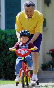 Grandfather and child on bike