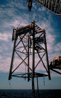 Photograph of an offshore crane at work.